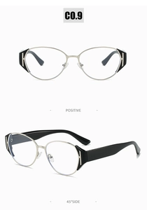 Detail view of cat-eye eyewear frames with gold metal hinges and black H-shaped cutouts