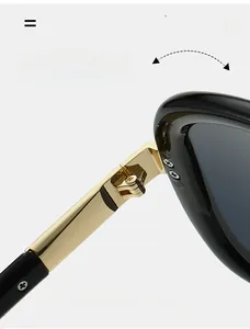 Détail de charnière dorée durable sur la monture noire de lunettes de soleil oversize