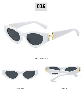 Detail of white cat-eye sunglasses with golden H-hinge accents and dark lenses