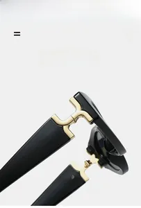 Detail of high-quality gold metal hinges and glossy black texture on sunglasses