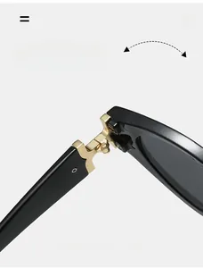 Macro detail of high-quality golden metal hinge on polished black fashion sunglasses