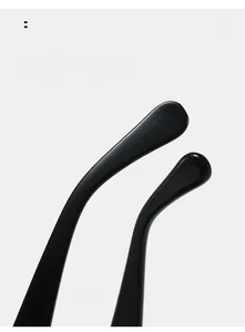 Detail view of ergonomic curved mirror legs on minimalist black polished sunglasses