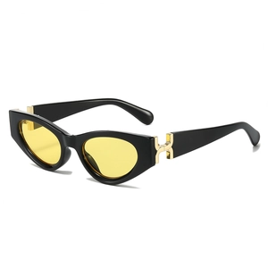Retro cat-eye sunglasses with black frame, yellow lenses, and gold metal hinge accents