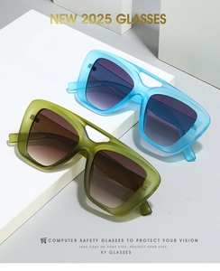 Close-up of modern double-bridge sunglasses in translucent blue and olive green colors
