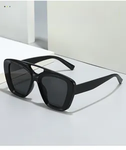 Close-up of double bridge black oversized sunglasses with thick frame and square design