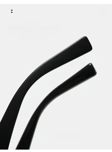 Detail of ergonomic curved temples on black double-bridge oversized sunglasses