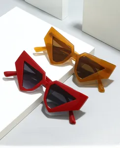 Detail of geometric thick frames in red and amber orange with dark UV protection lenses
