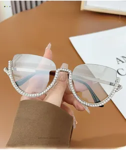 Detail of elegant semi-rimless sunglasses with luxury pearl embellishments and brown lenses