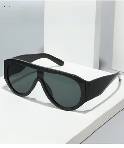 Detail of modern oversized shield sunglasses with black frames and dark grey lenses