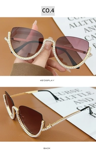 Detail of luxury half-frame cat-eye sunglasses with pearls and brown lenses