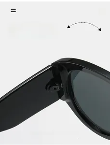 Detail of durable texture hinge and dark grey lenses on stylish oversized sunglasses