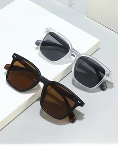 Detail of square sunglasses with faux wood grain temples on minimalist display