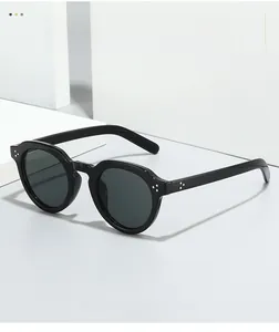Detailed side view of black oval sunglasses with triple silver metal rivets on the frame