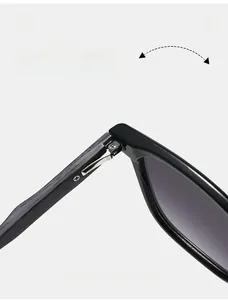 Detail of durable spring hinge on black square sunglasses showing flexible folding mechanism