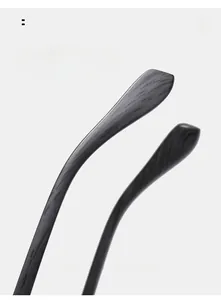 Detail of curved eyeglass temples with wood grain texture for comfortable wear