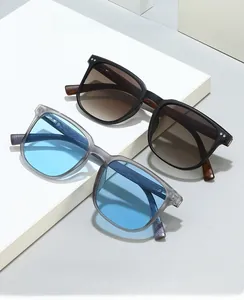 Detail of square computer glasses with wood grain texture and metal dot accents