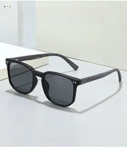 Close-up of black square sunglasses with textured gray wood grain temples and dark lenses