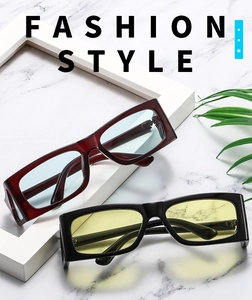 Detail of trendy rectangle sunglasses in dark red and black with stylish tinted lenses