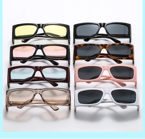 Flat lay of retro wide-frame sunglasses in multiple colors and diverse lens tints