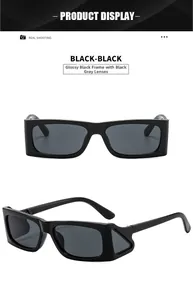 Detail view of glossy black rectangular sunglasses with side wing design and dark grey lenses