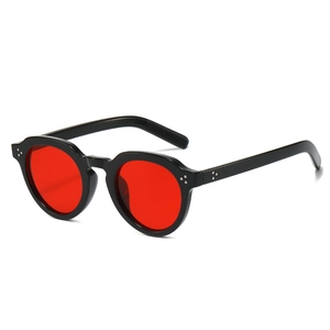 Retro oval sunglasses with thick black frame, red transparent lenses and metal rivets