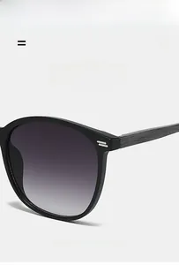 Detail of vintage oval sunglasses with wood grain texture temples and metallic rivet accents