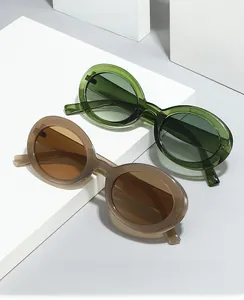 Close-up of vintage oval sunglasses in translucent olive green and grey on minimalist blocks