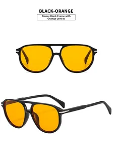 Detail of aviator sunglasses with black frames, orange lenses and silver arrow accents