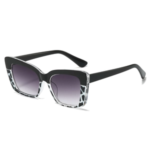Lunettes de soleil œil-de-chat tendance avec monture léopard bicolore et verres dégradés