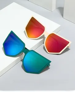 Detail of oversized geometric sunglasses with green and orange gradient coated lenses