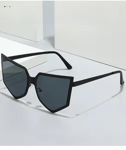 Detail of stylish oversized black pentagonal sunglasses on a minimalist stone pedestal