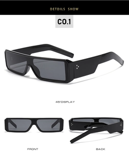 Detail view of black rectangular Y2K sunglasses with metallic triple-dot accents