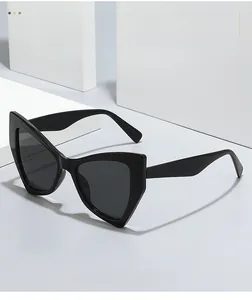 Close-up of texture material on black cat-eye sunglasses with dark lenses for women