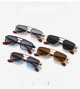 Detail of vintage aviator sunglasses with geometric metal double bridge and red temple tips