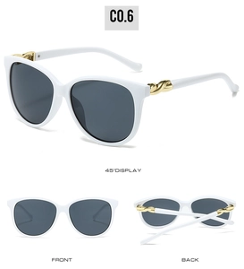 Detailed views of white vintage oversized sunglasses with golden twisted temple accents