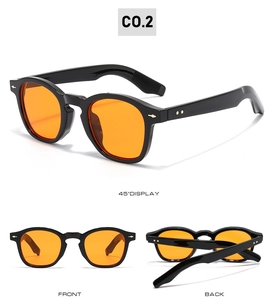 Close-up of retro square sunglasses with orange lenses and gold rivet metal details