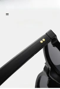 Macro shot of black glossy sunglasses with golden star rivets and lightweight material