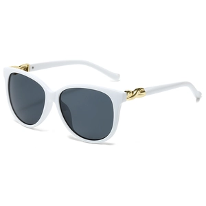 White oversized sunglasses with dark grey lenses and golden twisted metal temple detail