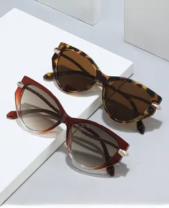 Close-up of cat-eye sunglasses with tortoise frames and golden triangular accents