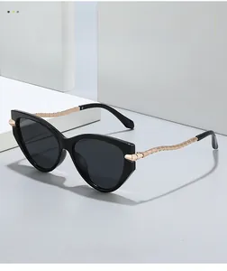 Detailed view of cat-eye sunglasses featuring golden twisted metal temple texture