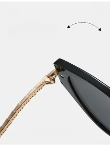 Close-up of durable golden metal hinges on elegant black cat-eye sunglasses