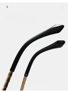 Detail of ergonomic curved temple tips with gold metal accents on sunglasses arm