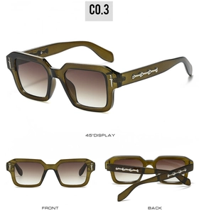 Detail view of olive green square sunglasses with silver metal cross ornaments and brown lenses
