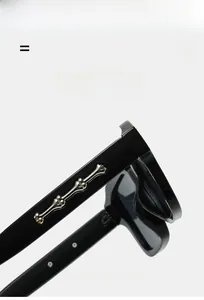 Macro detail of square sunglasses temple featuring punk silver bone metal decoration