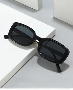 Close-up of black square frame glasses with grey lenses on white geometric stairs