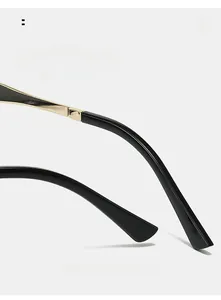 Detail view of black acetate temples with gold metal hinges on stylish sunglasses