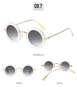 Detailed views of oval vintage sunglasses with white frames and gold metal temples