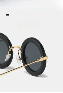 Detail view of oval retro sunglasses with gold metal temples and adjustable nose pads