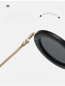 Close-up of durable golden metal hinges on oval sunglasses with black matte frames