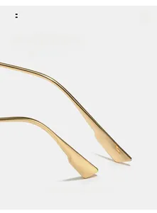 Detail of golden metal curved mirror legs with arc design for comfortable ergonomic wear
